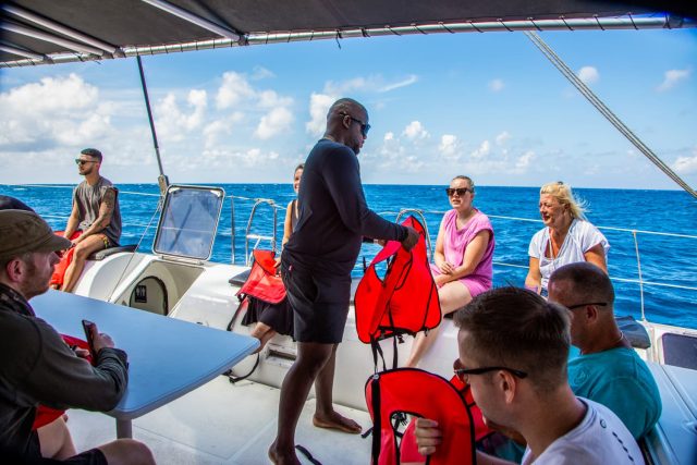 Handing out lifevests on boat