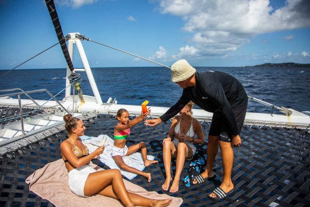 handing kid a drink on boat
