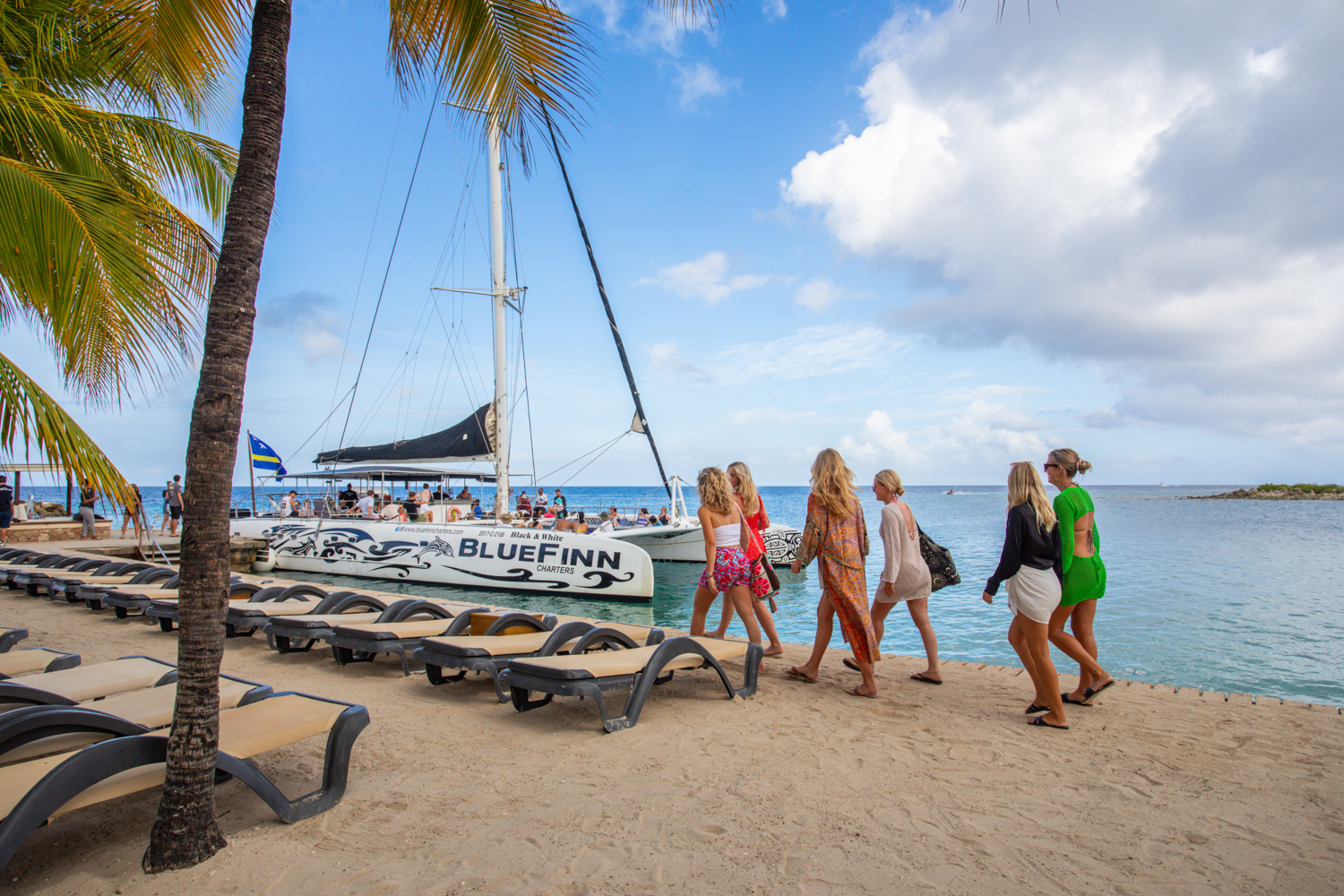 people boarding the boat from the beach