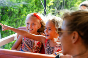 kids pointing in jeep
