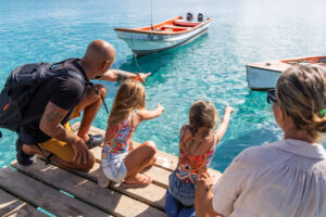 girls pointing at boats