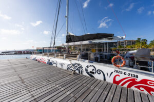 bluefinn red dragon by the dock with sail